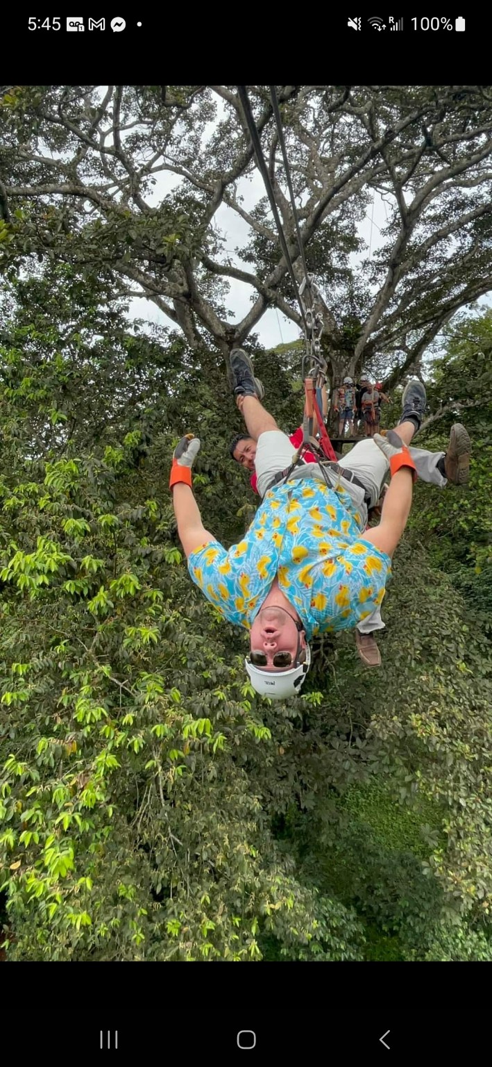 Ryan upside down on a jungle zipline