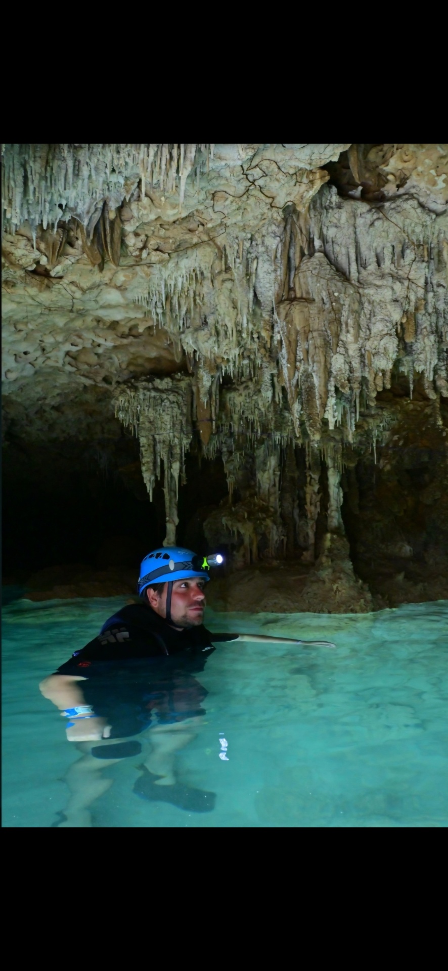 Ryan swimming through an underground cave